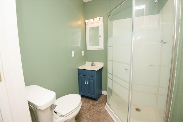 101 E Cronkhite St, Knoxville, IA 50138 - bathroom with a shower stall, toilet, vanity, and baseboards