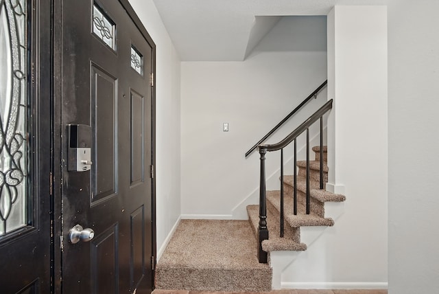 6700 Sheridan Ave, Des Moines, IA 50322 - entrance foyer featuring carpet floors, baseboards, and stairway