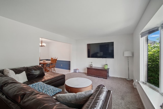 6700 Sheridan Ave, Des Moines, IA 50322 - living area with carpet floors, a chandelier, and baseboards