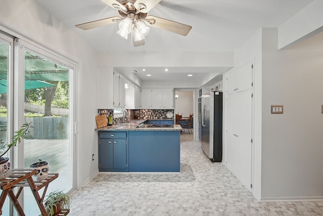6700 Sheridan Ave, Des Moines, IA 50322 - kitchen with stainless steel refrigerator with ice dispenser, backsplash, ceiling fan, a sink, and a peninsula