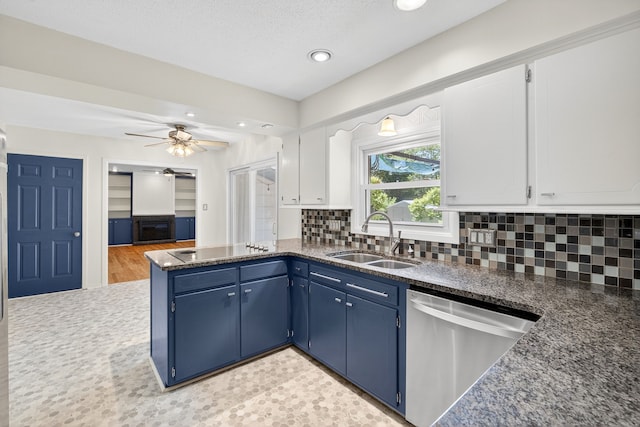 6700 Sheridan Ave, Des Moines, IA 50322 - kitchen featuring stainless steel dishwasher, black electric stovetop, blue cabinetry, a peninsula, and decorative backsplash
