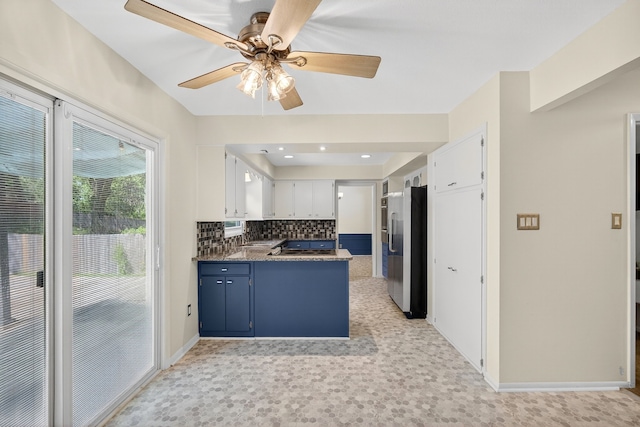 6700 Sheridan Ave, Des Moines, IA 50322 - kitchen featuring stainless steel refrigerator with ice dispenser, a peninsula, ceiling fan, backsplash, and dark countertops