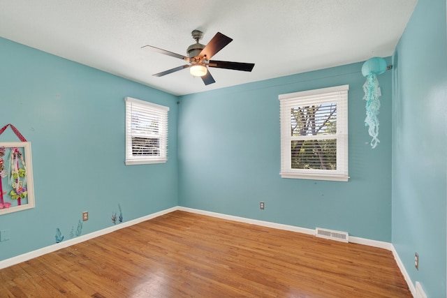 6700 Sheridan Ave, Des Moines, IA 50322 - empty room with wood finished floors and a ceiling fan