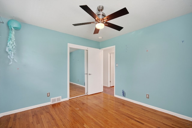 6700 Sheridan Ave, Des Moines, IA 50322 - unfurnished bedroom with wood finished floors and ceiling fan