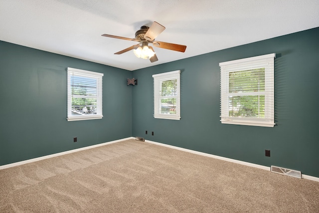 6700 Sheridan Ave, Des Moines, IA 50322 - unfurnished room featuring carpet floors and a ceiling fan