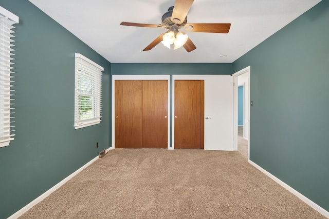 6700 Sheridan Ave, Des Moines, IA 50322 - unfurnished bedroom featuring two closets, carpet flooring, and a ceiling fan
