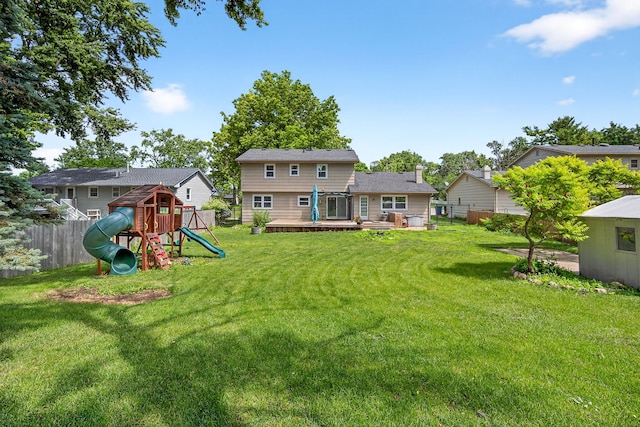 6700 Sheridan Ave, Des Moines, IA 50322 - rear view of house featuring a playground and a wooden deck