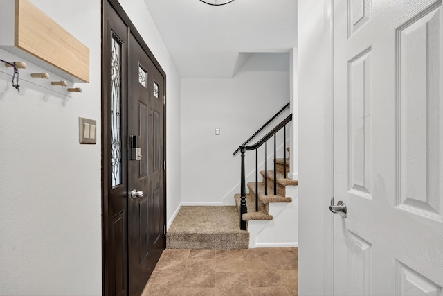 6700 Sheridan Ave, Des Moines, IA 50322 - carpeted entrance foyer with stairs and baseboards