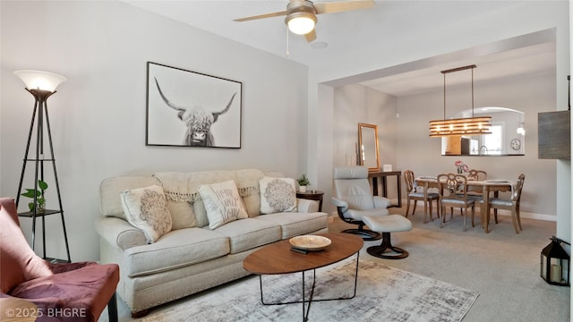 201 Grand Ave Unit 109, Des Moines, IA 50309 - living area with ceiling fan, carpet flooring, a chandelier, and arched walkways
