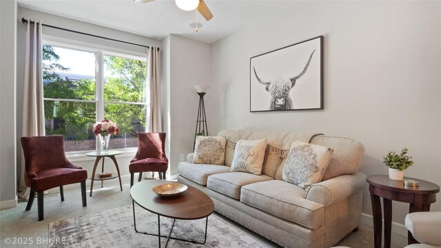 201 Grand Ave Unit 109, Des Moines, IA 50309 - carpeted living room featuring ceiling fan and baseboards