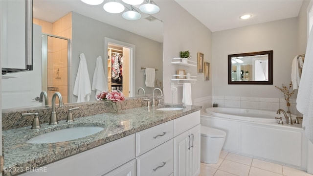 201 Grand Ave Unit 109, Des Moines, IA 50309 - full bath featuring tile patterned flooring, a stall shower, a walk in closet, a bath, and double vanity