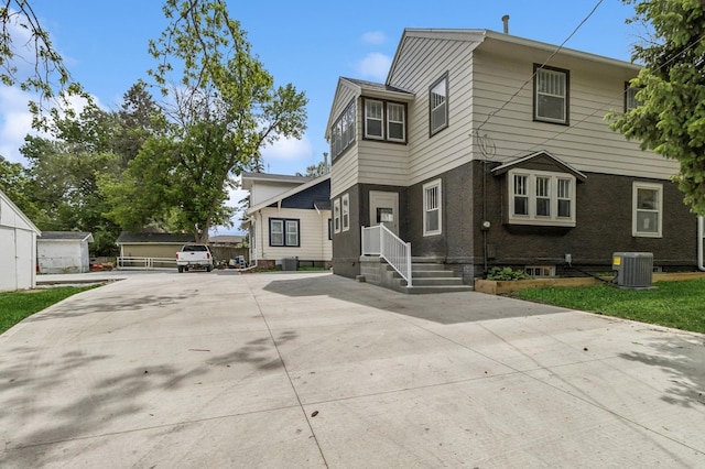 693 35th St, Des Moines, IA 50312 - view of front of property with central air condition unit and driveway