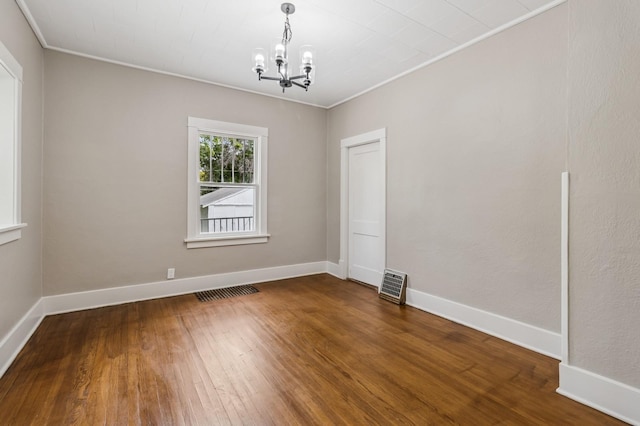 693 35th St, Des Moines, IA 50312 - empty room with a chandelier, ornamental molding, wood finished floors, and baseboards