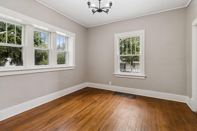 693 35th St, Des Moines, IA 50312 - empty room with a chandelier, plenty of natural light, hardwood / wood-style flooring, baseboards, and crown molding