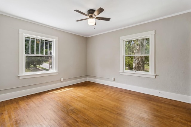 693 35th St, Des Moines, IA 50312 - unfurnished room featuring healthy amount of natural light, wood-type flooring, baseboards, crown molding, and a ceiling fan