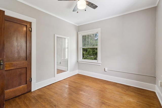 693 35th St, Des Moines, IA 50312 - unfurnished bedroom featuring wood finished floors, baseboards, crown molding, and a ceiling fan