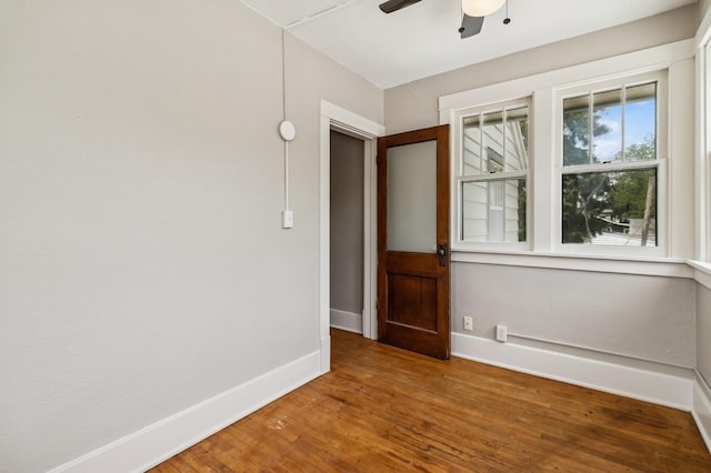 693 35th St, Des Moines, IA 50312 - unfurnished room with a ceiling fan, wood finished floors, and baseboards