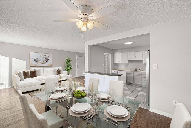 1240 49th St Unit 5, West Des Moines, IA 50266 - dining area with a ceiling fan, baseboards, a textured ceiling, and light wood-type flooring