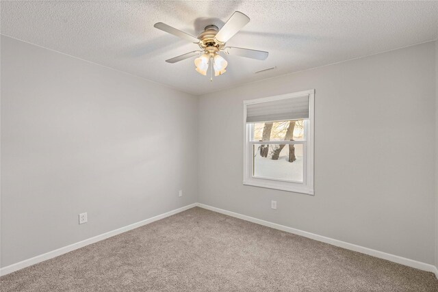 1240 49th St Unit 5, West Des Moines, IA 50266 - empty room with carpet flooring, baseboards, a textured ceiling, and ceiling fan