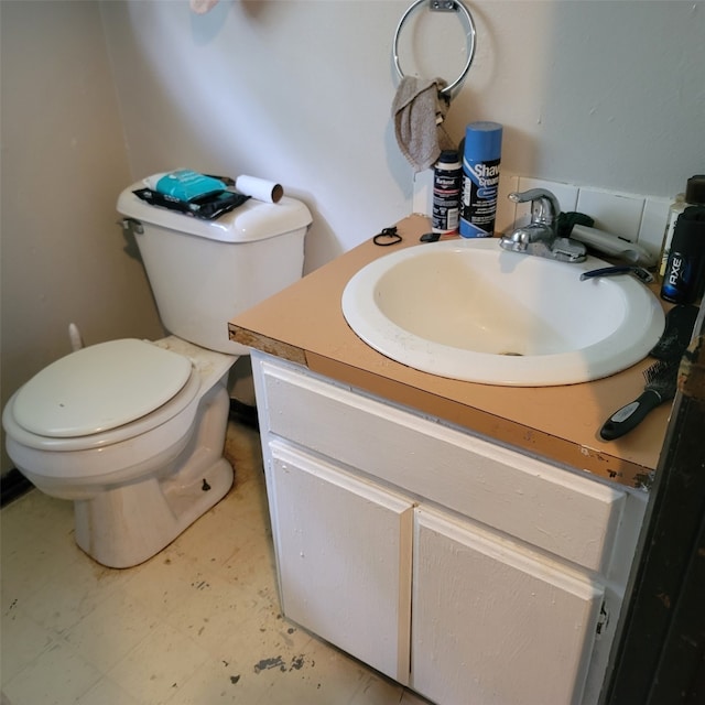 1850 King Ave, Des Moines, IA 50320 - half bathroom with vanity, toilet, and tile patterned floors