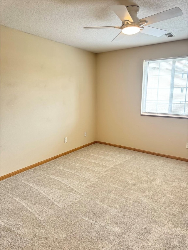 10141 Sutton Dr Unit 7, Urbandale, IA 50322 - spare room featuring light colored carpet, ceiling fan, a textured ceiling, and baseboards