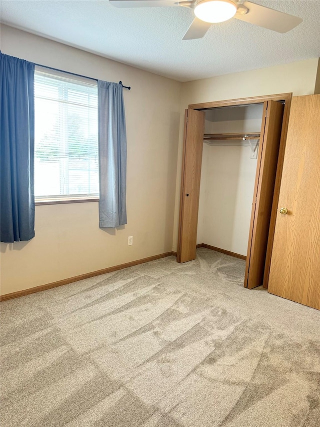 10141 Sutton Dr Unit 7, Urbandale, IA 50322 - unfurnished bedroom with carpet, a closet, and a ceiling fan