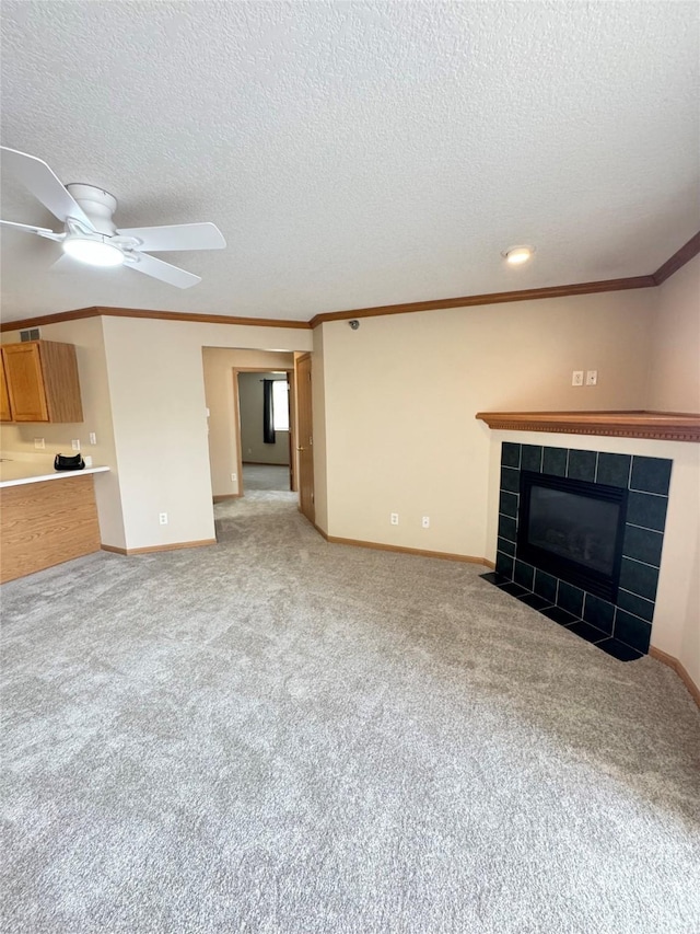 10141 Sutton Dr Unit 7, Urbandale, IA 50322 - unfurnished living room featuring crown molding, light colored carpet, baseboards, a ceiling fan, and a textured ceiling