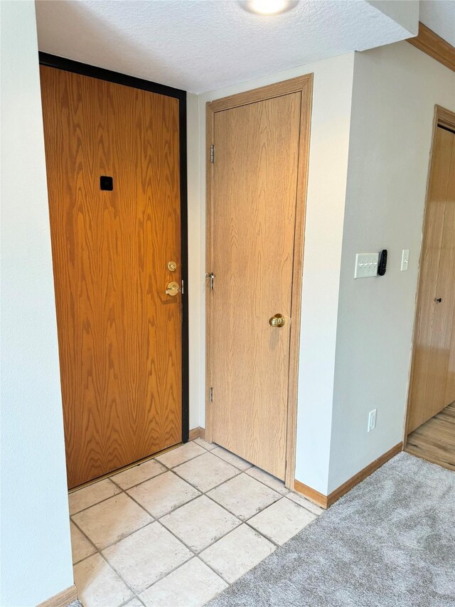 10141 Sutton Dr Unit 7, Urbandale, IA 50322 - interior space featuring a textured ceiling and baseboards