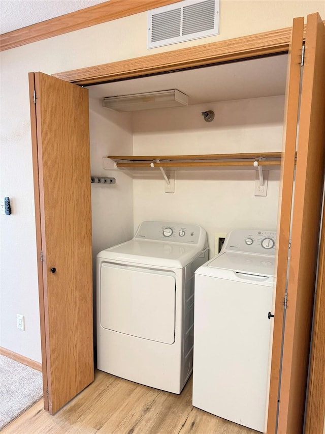 10141 Sutton Dr Unit 7, Urbandale, IA 50322 - clothes washing area with separate washer and dryer and light wood-type flooring