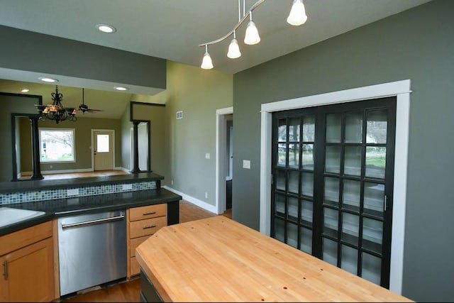 1604 Mamie Eisenhower Ave, Boone, IA 50036 - kitchen with stainless steel dishwasher, butcher block countertops, a chandelier, pendant lighting, and baseboards