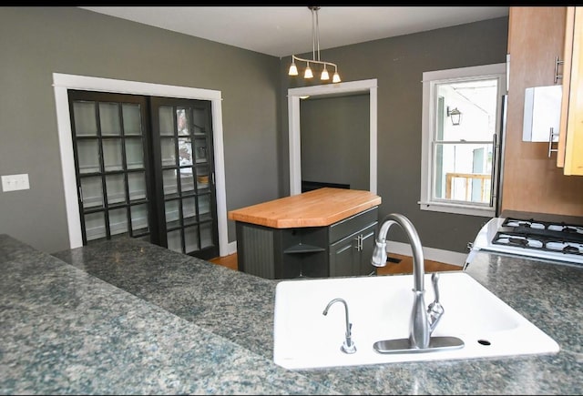 1604 Mamie Eisenhower Ave, Boone, IA 50036 - kitchen with a sink, wooden counters, baseboards, pendant lighting, and range