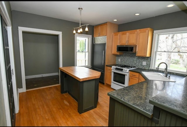 1604 Mamie Eisenhower Ave, Boone, IA 50036 - kitchen featuring stainless steel microwave, white range with gas cooktop, butcher block counters, a sink, and tasteful backsplash