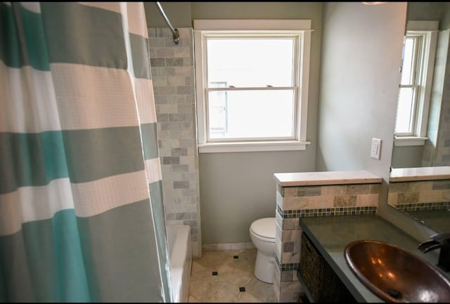 1604 Mamie Eisenhower Ave, Boone, IA 50036 - full bathroom featuring tile patterned flooring, plenty of natural light, toilet, and vanity