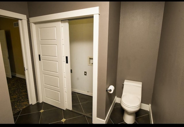 1604 Mamie Eisenhower Ave, Boone, IA 50036 - bathroom featuring toilet, tile patterned flooring, and baseboards