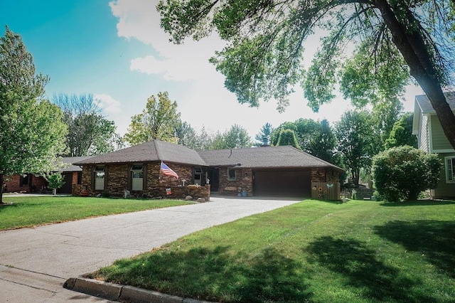 ranch-style home with a garage, concrete driveway, and a front lawn