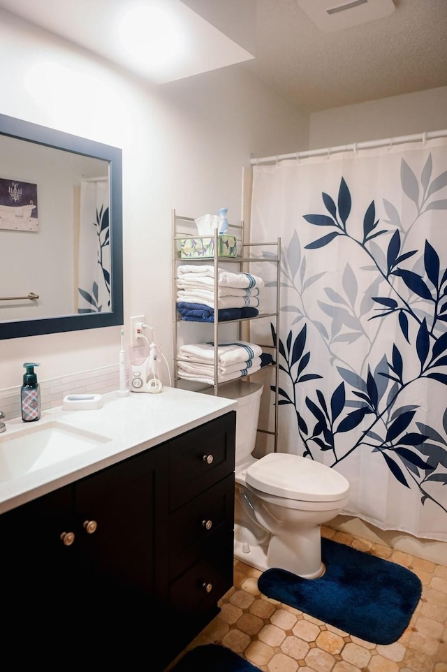bathroom with vanity, toilet, and a shower with shower curtain