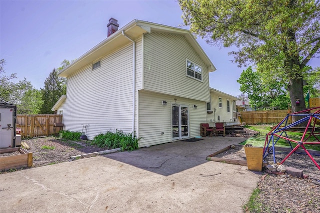 406 NW Kimberly Ln, Ankeny, IA 50023 - rear view of house featuring a patio area, a chimney, and a fenced backyard