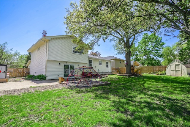 406 NW Kimberly Ln, Ankeny, IA 50023 - rear view of house featuring a storage shed, a chimney, an outbuilding, and a patio area