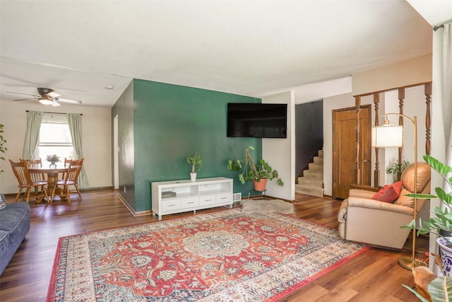 406 NW Kimberly Ln, Ankeny, IA 50023 - living area featuring a ceiling fan, wood finished floors, stairway, and baseboards