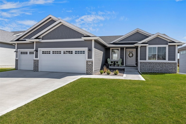 980 Daybreak Dr, Waukee, IA 50263 - craftsman-style home featuring a garage, driveway, a front lawn, and brick siding