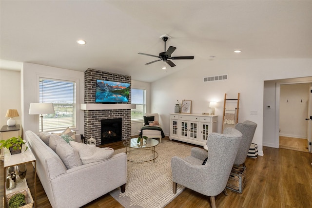 980 Daybreak Dr, Waukee, IA 50263 - living area featuring wood finished floors, a ceiling fan, vaulted ceiling, a fireplace, and baseboards