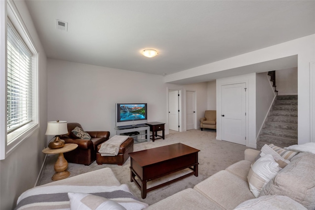 980 Daybreak Dr, Waukee, IA 50263 - carpeted living area with stairway, healthy amount of natural light, and baseboards