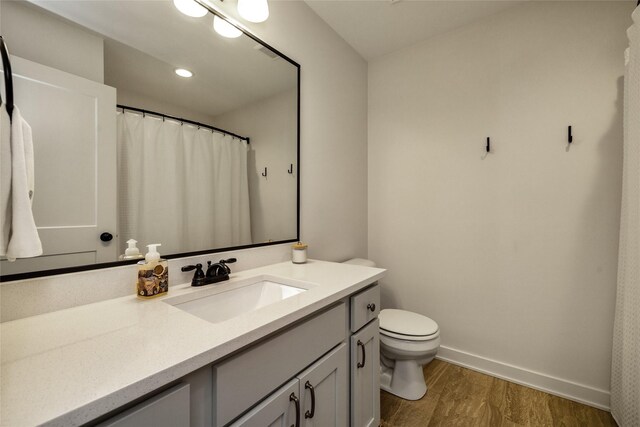 980 Daybreak Dr, Waukee, IA 50263 - full bath with vanity, wood finished floors, toilet, and baseboards
