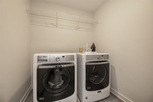 980 Daybreak Dr, Waukee, IA 50263 - laundry area with baseboards, washing machine and clothes dryer, and wood finished floors