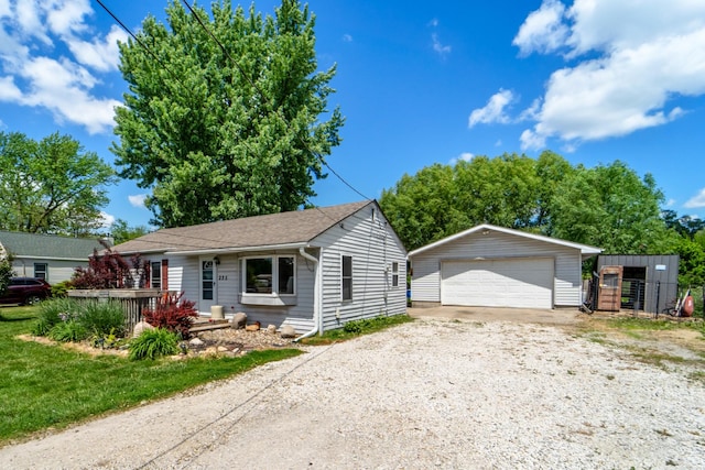 225 NW 50th Pl, Des Moines, IA 50313 - ranch-style house with an outdoor structure, a detached garage, and roof with shingles