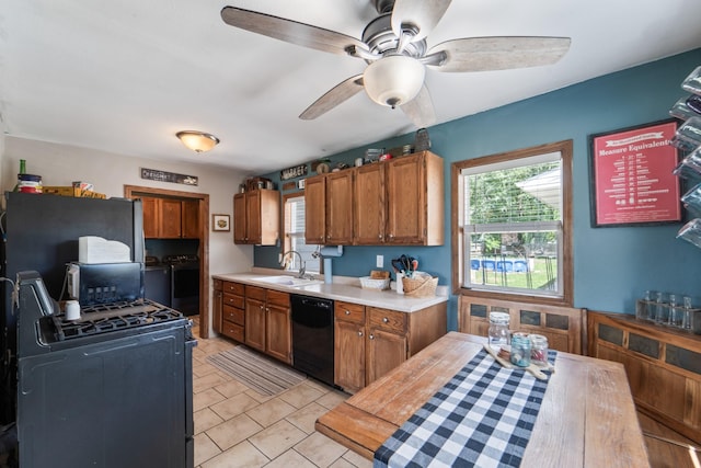 225 NW 50th Pl, Des Moines, IA 50313 - kitchen with dishwasher, independent washer and dryer, a sink, light countertops, and ceiling fan