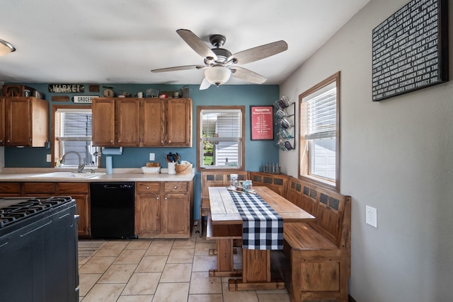 225 NW 50th Pl, Des Moines, IA 50313 - kitchen featuring black appliances, a sink, light countertops, and brown cabinetry