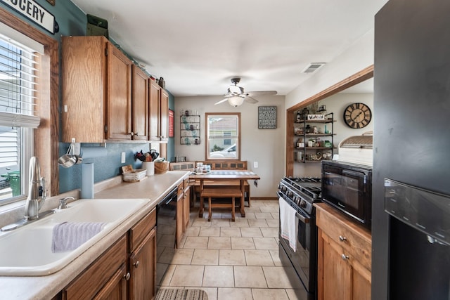225 NW 50th Pl, Des Moines, IA 50313 - kitchen featuring black appliances, a sink, ceiling fan, brown cabinets, and light countertops