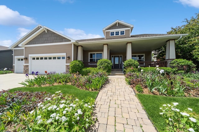 1420 Hannah Ln, Waukee, IA 50263 - craftsman-style home with a garage, covered porch, driveway, and stone siding