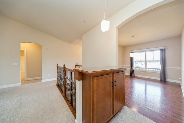 1420 Hannah Ln, Waukee, IA 50263 - corridor with arched walkways, baseboards, an upstairs landing, light wood-style floors, and lofted ceiling